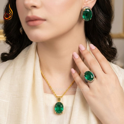 Emerald stone with E zircon set